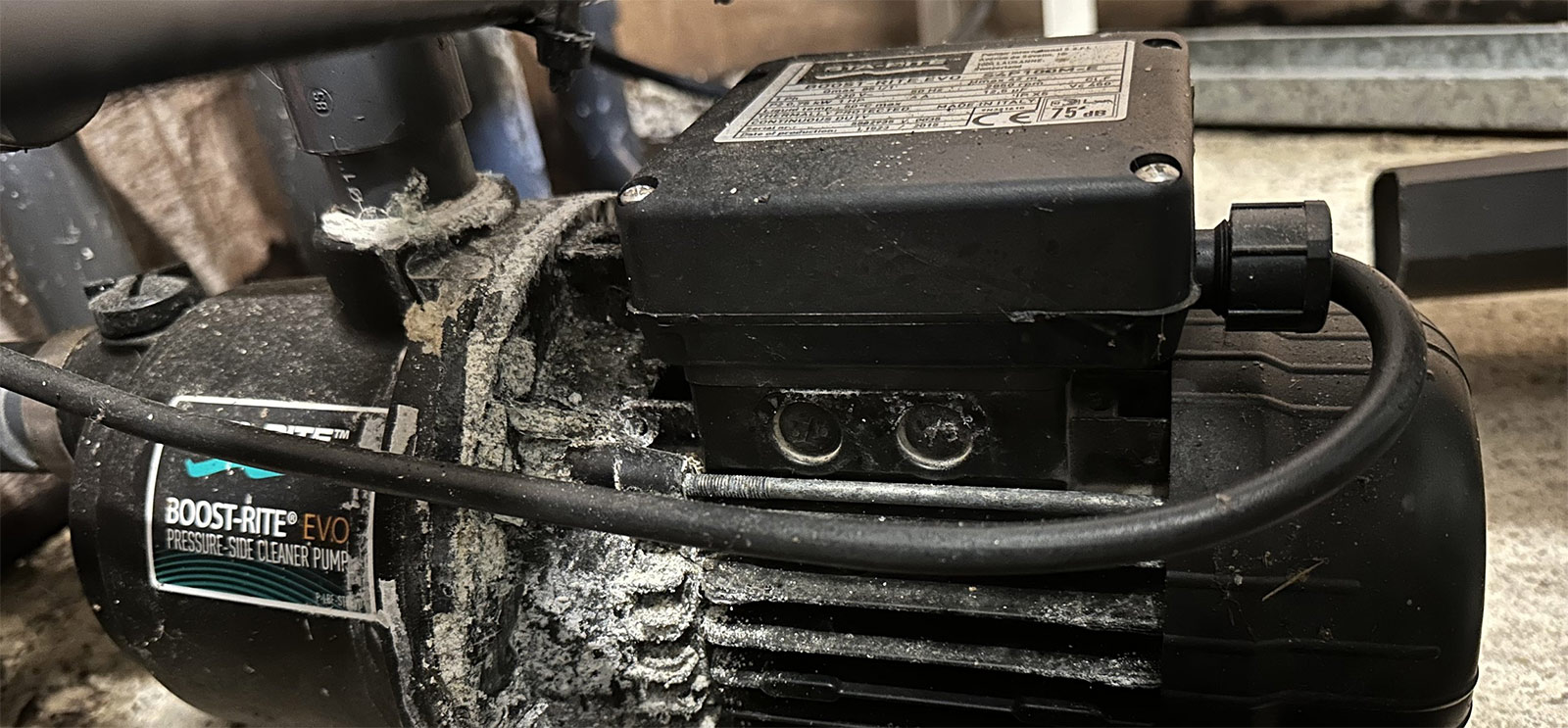 A pool pump on a workshop bench