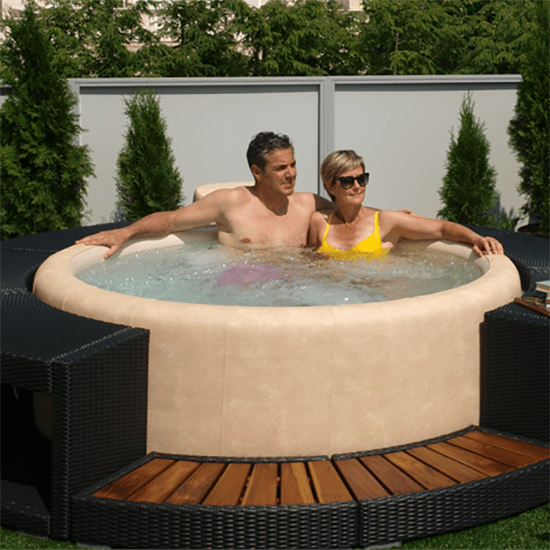 A Softub hot tub in a garden setting