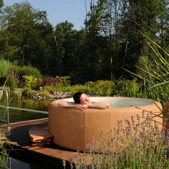 A Softub hot tub in a garden setting