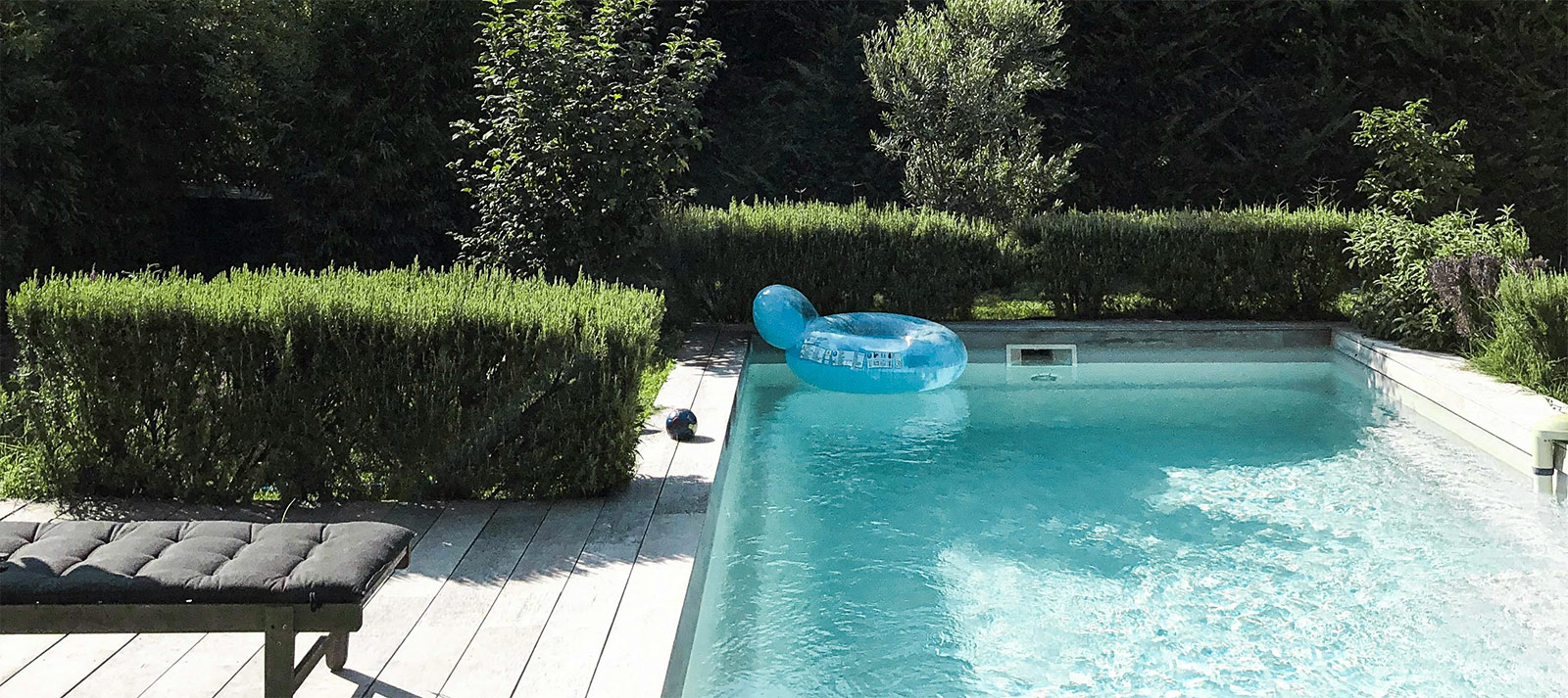 A garden swimming pool with a float on the water